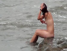 Tanned Nudist Is Walking On The Beach