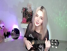 Charming Blonde Slut Playing On Ukulele And Singing In Kinky Outfit