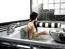 Big Breasted Brunette Slowly Taking Off Her Swimsuit And Slowly Teasingly Posing In The Bath Full Of Water