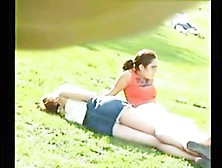 Busty Chick Is Just Relaxing On The Grass In Park