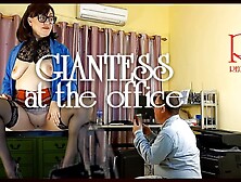 A Giant Secretary Sits On An Office Desk.  The Manager Guy Is Very Surprised At Her Height.