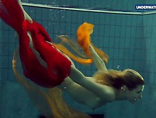 Wet Yellow And Red Clothed Teen Underwater