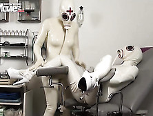 Kinksters In Latex And Restrictive Masks Play With An Exposed Pussy In A Medical Setting.