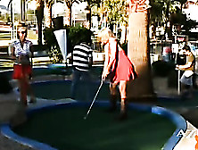 Blonde Angie Plays Golf With A Sexy Red Dress And You Can See Her Legs And Boobs When She’S Leaning