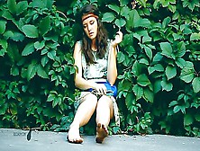 Adorable Brunette Hippy Gal Sits In Shrubs And Her Dirty Feet While Smoking