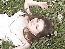 Young Brunette Posing In A Flower Field