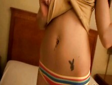 Hot Brunette Chick Shows Her Navel Piercing And Tattoo