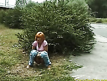 Red Haired Slut Takes A Pee Behind A Bush Near A Highway