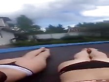 Sunbathing With Friend On Trampoline