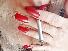 Mature Shemale With Strong Red Lipstick Teases While Smoking Seductively