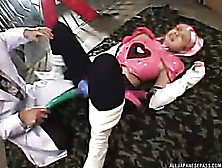 Asian Hottie In Pink And Black Anime Costume Lays Down On A Black And Gray Carpet And Lets A Horny Dude Rub A Big Vibrator On He
