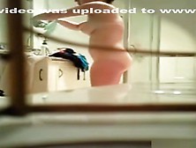 Voyeur Tapes A Brunette Taking Care Of Her Naked Body In The Bathroom