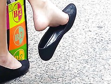 Girl Relaxes,  Twirling Around Her Shoe While Her Feet Are Filmed By Hidden Camera