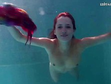 Saucy Underwater Teen Flashes Her Assets