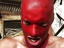 Slave In Red Latex Used By Dommes