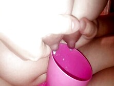 Young Mother Pours Milk Inside A Cup