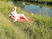 Nudist Beach.  Public Nudity.  Sexy Milf Without Panties And Bra Sunbathes Naked Is Not Shy About Fisherman.  Naked In Public.  Milf