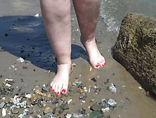 Thick Unprotected Legs With Red Pedicure Walk Along The Bank Of The River,  Bizarre.