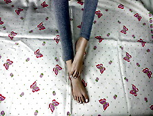 Girl In Gray Leggings With Long Legs Caresses Her Feet With A Pedicure