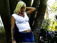 A Short Jean Skirt Looks Great On A Blonde's Ass As She's Outside Smoking Her Ciggy.