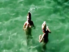 Nudist Allies On The Beach (Between 'em)