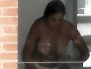 Busty Woman Filmed In Secret While Naked Next To The Window