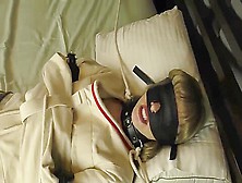 Blindfolded With Straight Jacket On Bed