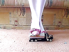 Schoolgirl In Stilettos Crushes Toy Truck And Car