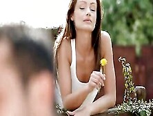 As She Wanders Outdoors And Stops To Pick A Dandelion,  Sophie Lynx Indulges In A Hidden Smile In Anticipation Of