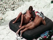 Naked Couple Tans On The Beach