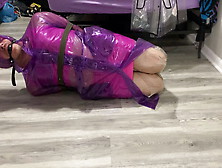 Hogtied In Purple Plastic Raincoat